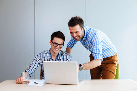 Two web designers looking at a website they designedの写真素材