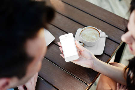 Close-up of a woman hand holding a smartphoneの写真素材