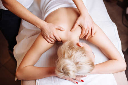 Young blond woman at a masseur's