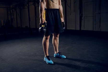Young muscular man  training with kettlebellsの写真素材