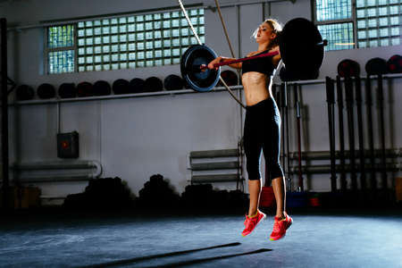 Woman training snatch at gymの写真素材