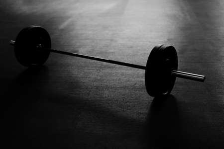 Black and white picture of barbells on the gym floorの写真素材
