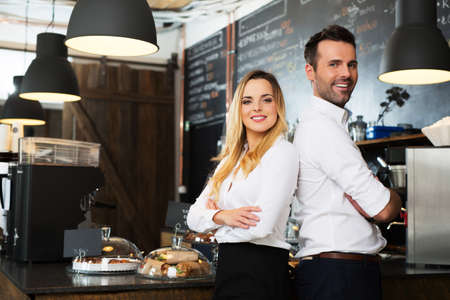 Small business partners standing together at their coffee shop, cafeの写真素材