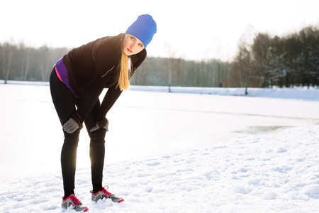 Young woman rest after winter runの写真素材