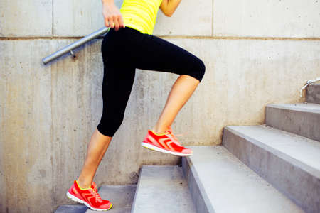 Woman running up the stairs, interval trainingの写真素材