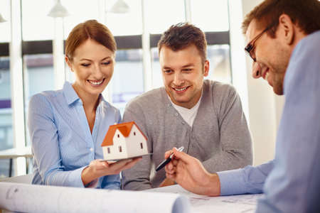 Happy couple choosing new home design with architectの写真素材