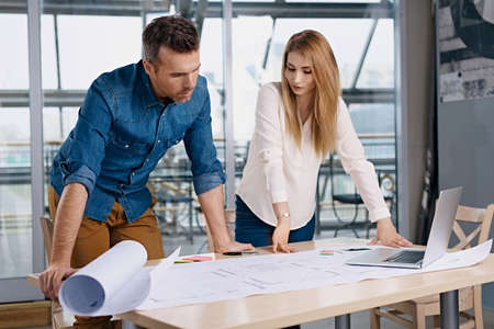 Two architects working on new design at modern officeの写真素材