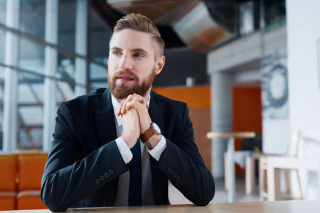 Confident young businessman looking awayの写真素材