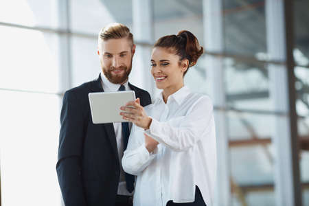 Businesswoman presenting business data on digital tablet at meetingの写真素材