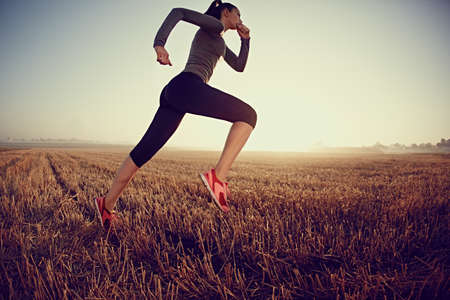 Young sporty woman running at morningの写真素材