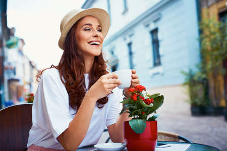 Attractive woman drinking coffee in the cityの写真素材