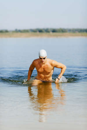 Triathlete running out of the water on triathlon race.の写真素材