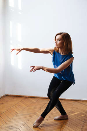 Female ballet dancer warming up before the performanceの写真素材