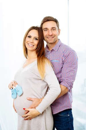 Happy man touching his pregnant wife's stomachの写真素材