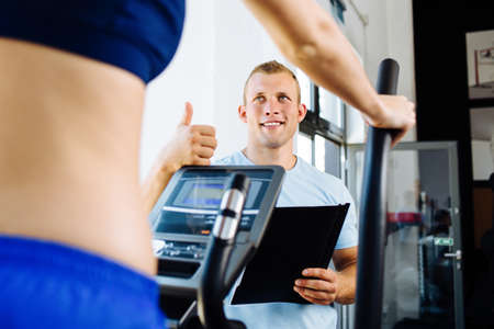 Photo of a fitness trainer praising his traineeの写真素材
