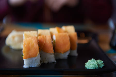 Sushi with avocado and kale on plate with wasabi