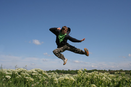 Flying man jump high and going to make kick by foot. Fighter kick on the flyの写真素材