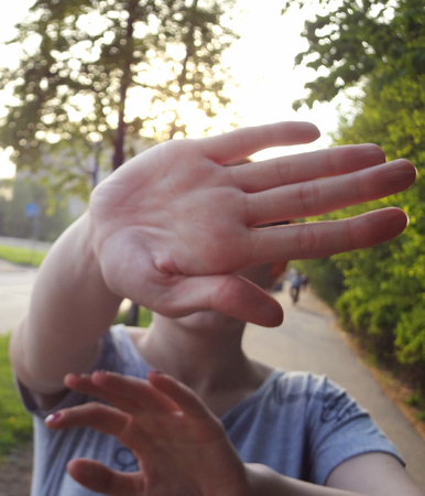 Not shoot sign by hand. Woman pop up palm not allowing to shoot her face