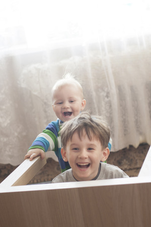 Boys play with each other laughing a lot enjoying childhood together. Copy space above headsの写真素材