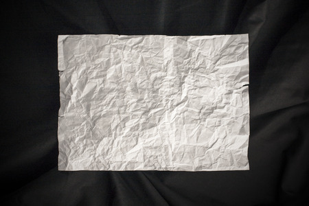 Crumpled paper texture landscape orientation on black background.の写真素材
