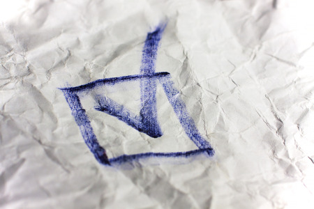 Check mark in checkbox on crumpled paper. Vote for candidate and angry. Elections concept