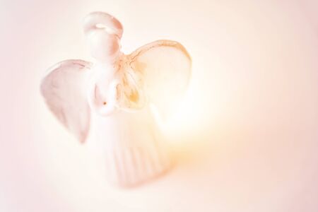 Praying angel toy christmas background. Copy space for merry christmas greeting card