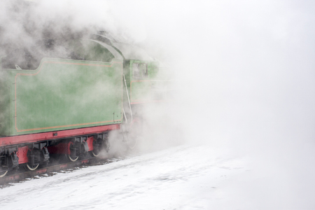 Clouds of vapor around the green steam train. Vintage techic for good ecologyの写真素材