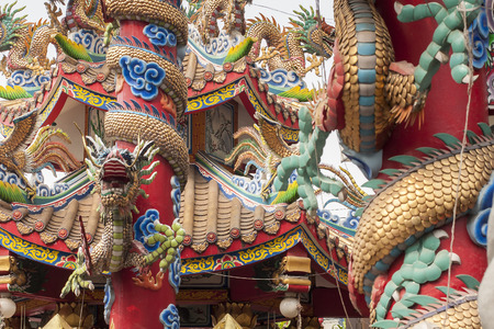 Thai buddhist temple close up. Asian dragons texture in architecture.の写真素材