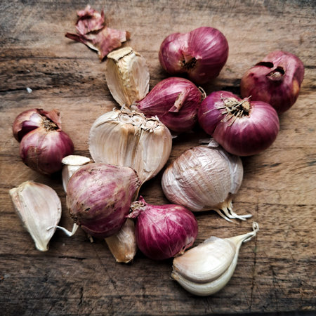 Garlic Bulbs and Red Onions on Rustic Wooden Background