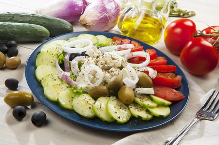 Plate of traditional Greek salad on the wooden tableの写真素材