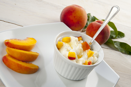 Mousse with peaches served in a bowl and plateの写真素材
