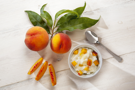 yoghurt mousse with whole side peachesの写真素材