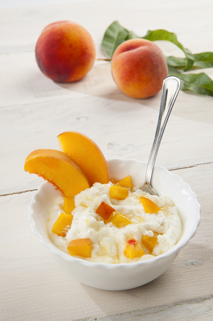 Bowl with peach mousse with peach backgroundの写真素材