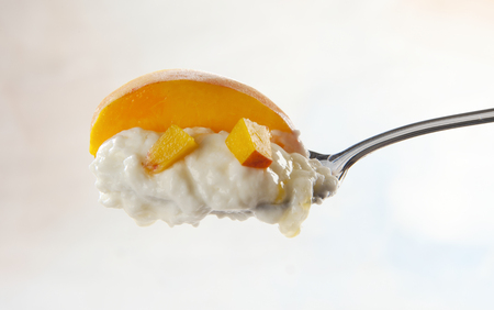 spoon with over mousse with peachesの写真素材