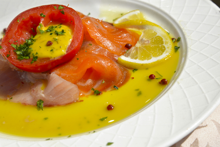 appetizer of salmon and swordfish with lemon cream and currantsの写真素材