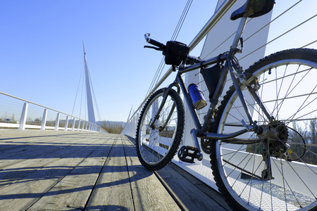 Mountain biking on a modern suspension bridgeの写真素材