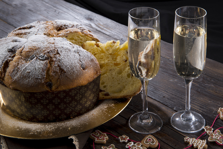 Christmas Panettone with sparkling wine and Christmas decorations on wooden tableの写真素材