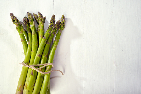 Green asparagus on a white wooden tableの写真素材