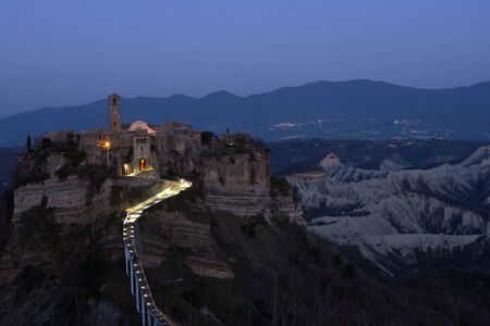 Pedestrian walkway of Civita di Bagnoregio in Umbria, Italy, at sunsetの写真素材