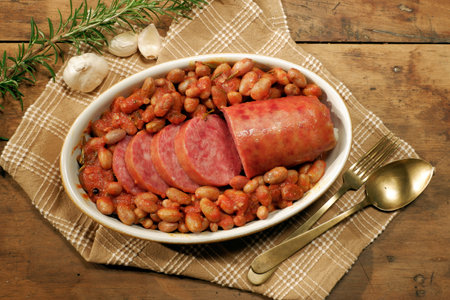 Cotechino, a typical Modenese dish, boiled and served with beans in an oval bowlの写真素材