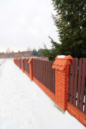 fence with wooden railings and brick pillarsの写真素材