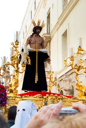 Easter procession during Holy Week in Spain. The float with Jesus figure. Cadiz, Andalucia, Spain
