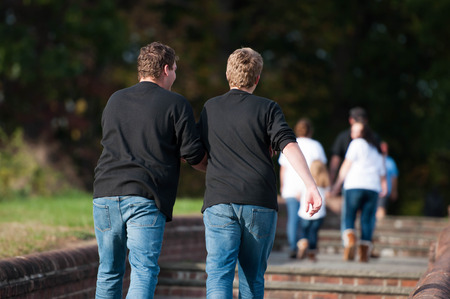Two Boys Walking Together Through a Parkの写真素材