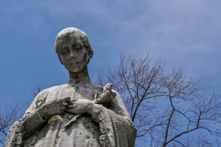 Statue of a Boy Looking Down Upon a Grave in a Cemeteryのeditorial素材