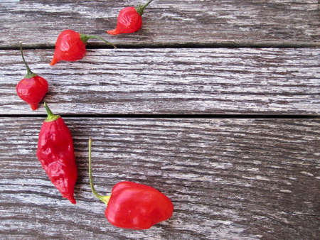 Red chili pepper over an antique tableの写真素材
