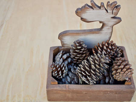 elk-shaped wooden container for pine cones on right positionの写真素材