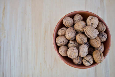 Walnuts on  earthenware container - above