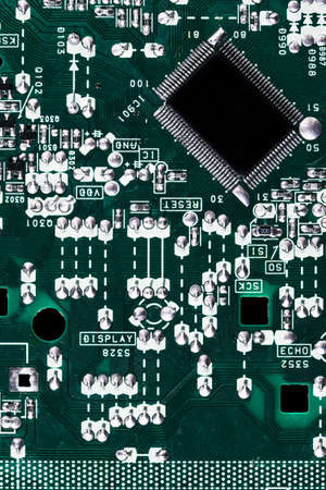 Microchip integrated on green motherboard computer science macro shot