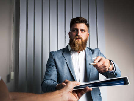 Businessman in office late night work signing contractの写真素材