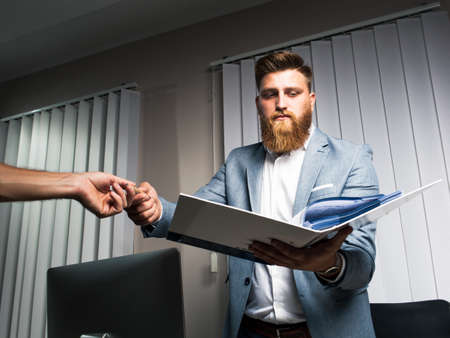 Businessman in office late night work signing contractの写真素材